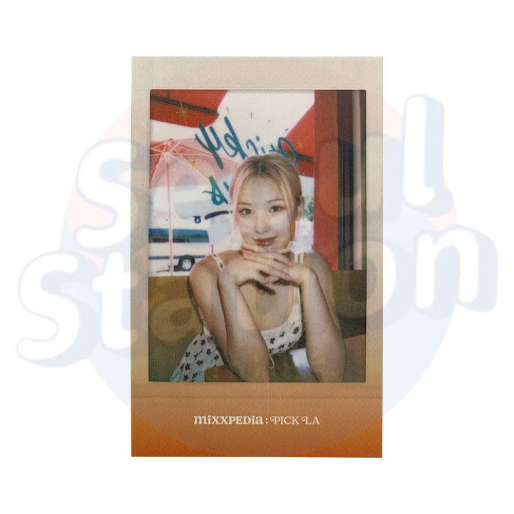 NMIXX - MIXXPEDIA : PICK LA - Polaroid Type Photo Card jinni sitting on table